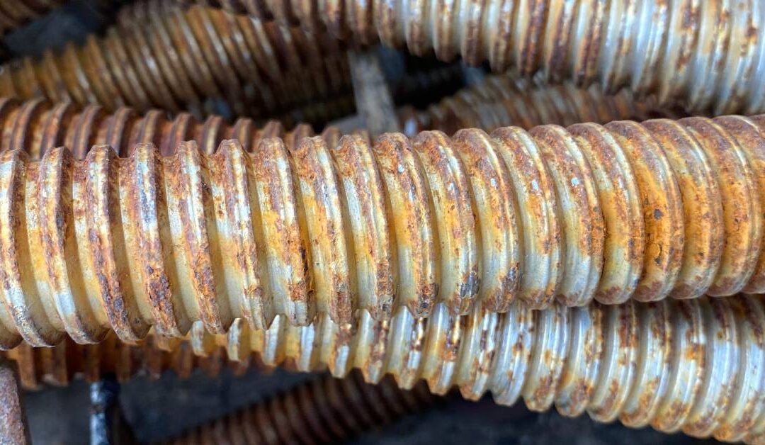 Rusty metal debris at an industrial site, showcasing the texture and corrosion effects on various metal surfaces.